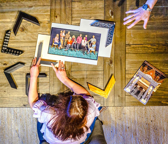 Corner Frame Shop - About page image, looking down on a table of a picture getting framed